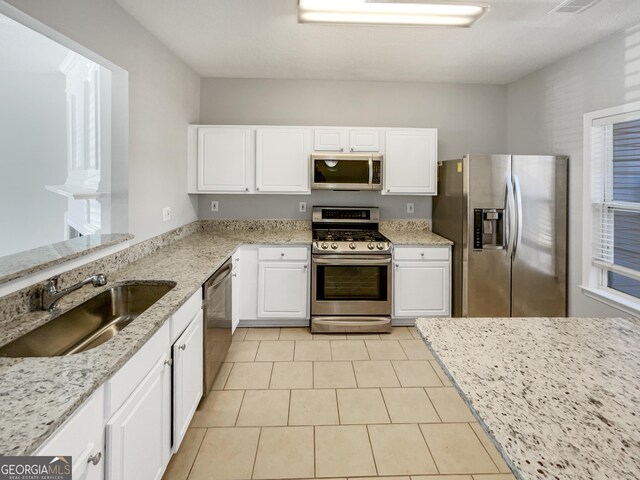 kitchen with a healthy amount of sunlight, hanging light fixtures, and light hardwood / wood-style flooring