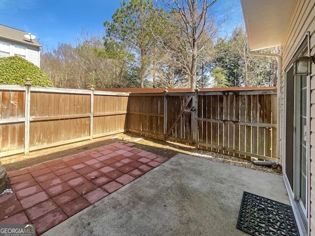 view of patio / terrace featuring fence and a gate