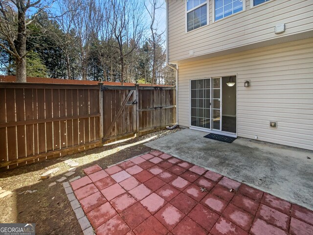 view of patio with a gate and fence