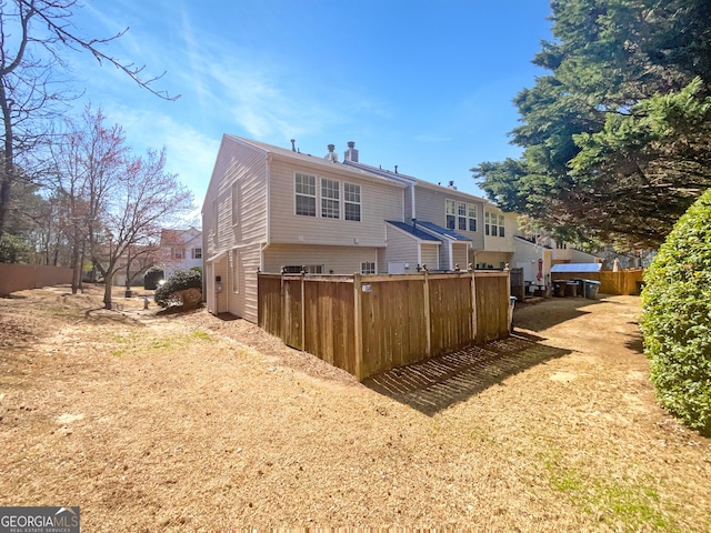 back of property featuring fence