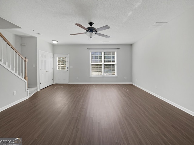 unfurnished living room featuring stairway, baseboards, dark wood-style flooring, and ceiling fan