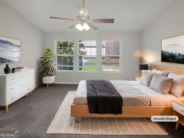 carpeted bedroom featuring lofted ceiling, baseboards, and ceiling fan