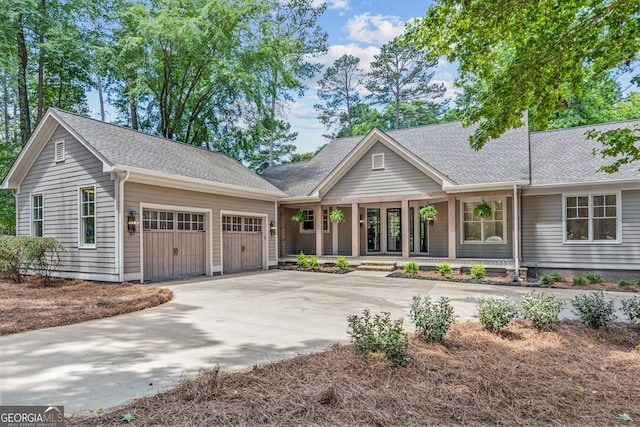 view of front of house featuring covered porch and a garage