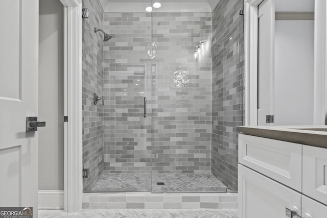 bathroom with vanity and a shower with shower door