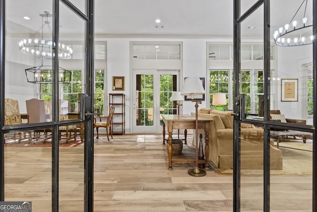 interior space featuring french doors and an inviting chandelier