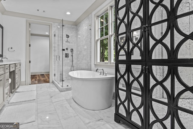 bathroom featuring plus walk in shower and vanity