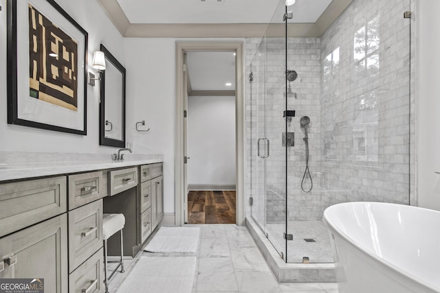 bathroom featuring vanity, ornamental molding, and shower with separate bathtub