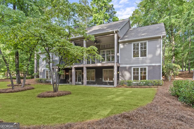 rear view of house with a lawn, ceiling fan, and a patio area