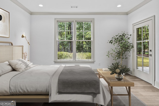 bedroom featuring access to outside, light hardwood / wood-style flooring, and ornamental molding