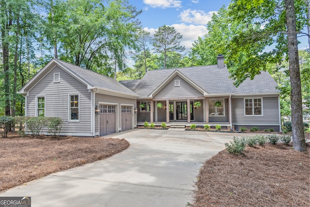 single story home featuring a porch and a garage