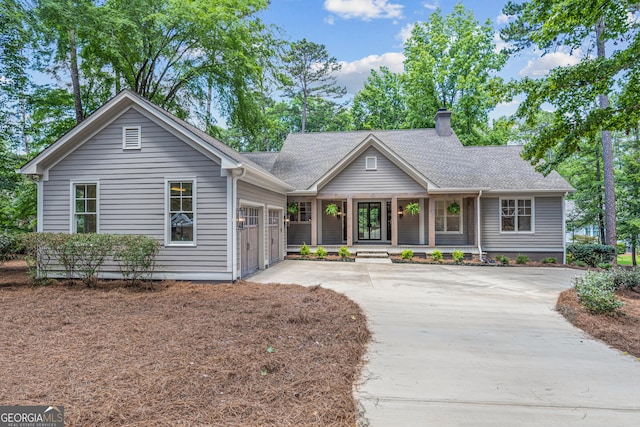 single story home featuring a porch and a garage