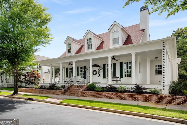 cape cod house featuring ceiling fan and covered porch