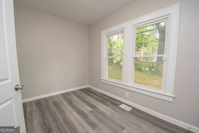 empty room with dark wood-type flooring