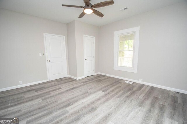 unfurnished room with ceiling fan and hardwood / wood-style floors