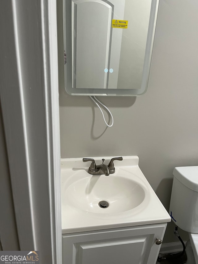 bathroom with toilet and vanity