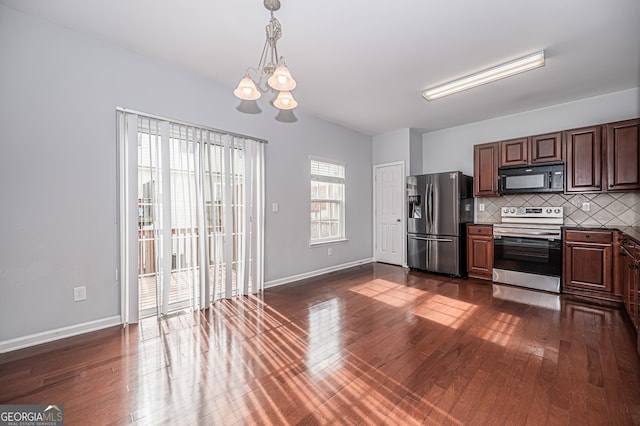 kitchen featuring an inviting chandelier, appliances with stainless steel finishes, dark hardwood / wood-style floors, and decorative backsplash