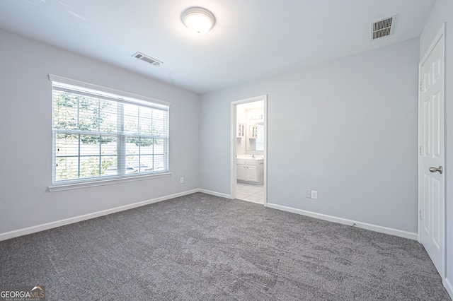 unfurnished room featuring light colored carpet