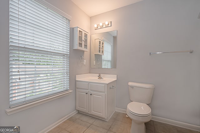 bathroom featuring tile patterned flooring, vanity, and toilet