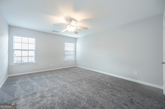 carpeted spare room featuring ceiling fan