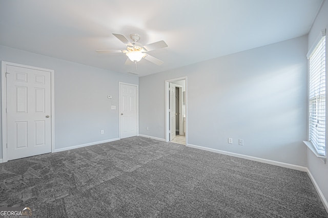 unfurnished room with ceiling fan and carpet floors