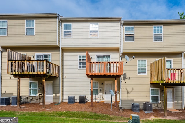 rear view of house featuring a balcony, a patio, and central air condition unit