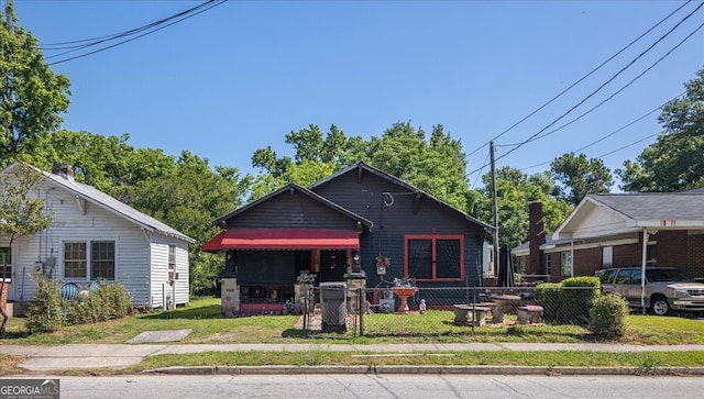 bungalow-style home with a front lawn