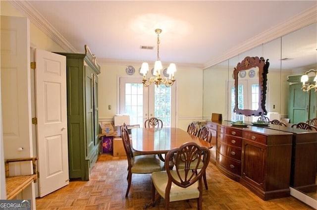 dining space with ornamental molding, light parquet flooring, french doors, and a notable chandelier