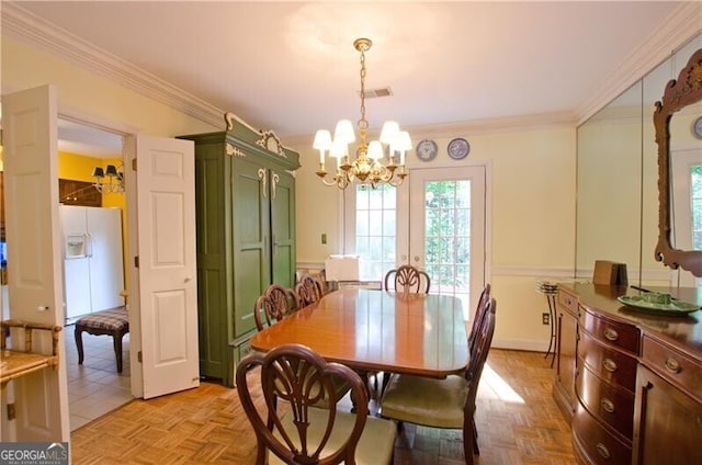 dining room with french doors, light parquet floors, a notable chandelier, and crown molding