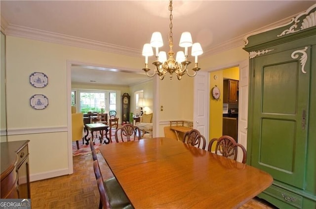 dining space featuring a notable chandelier, dark parquet flooring, and crown molding