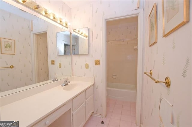 bathroom featuring tile patterned flooring, vanity, and tiled shower / bath