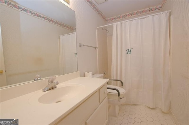 bathroom with vanity, curtained shower, and toilet