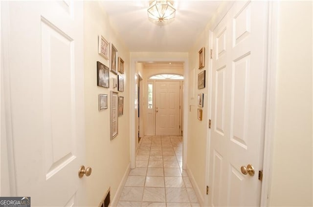 corridor with light tile patterned floors