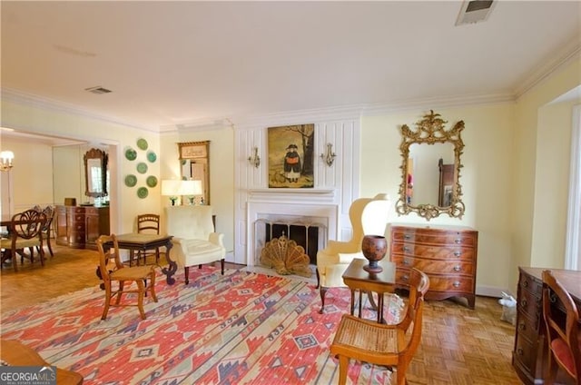 sitting room with parquet flooring, an inviting chandelier, and ornamental molding