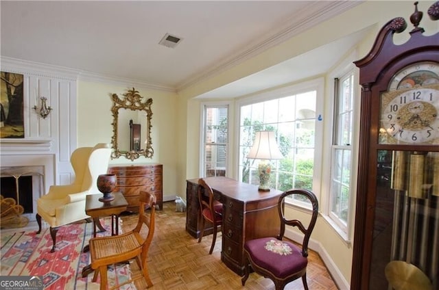 sitting room featuring plenty of natural light, crown molding, and light parquet flooring