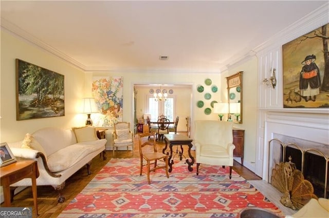 living area with a chandelier and crown molding