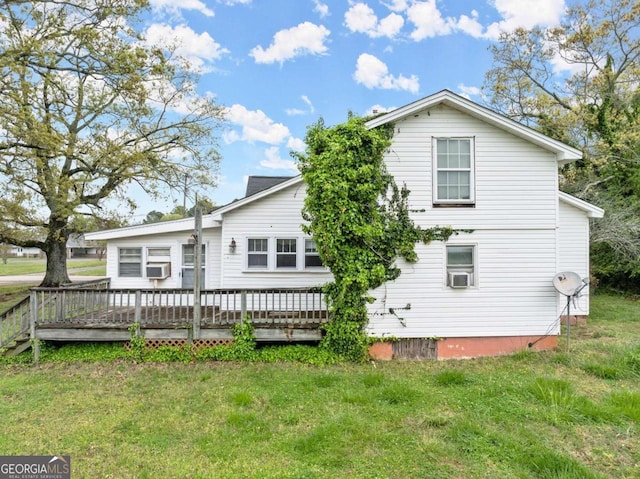 rear view of house with a yard, cooling unit, and a deck