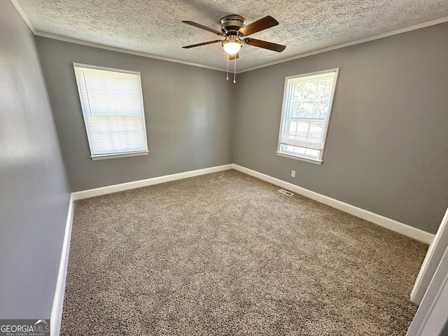 spare room featuring crown molding, carpet floors, a textured ceiling, and ceiling fan