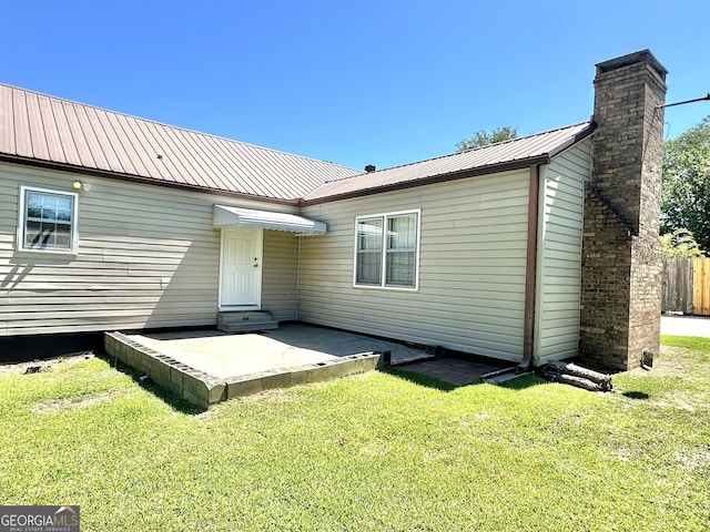 rear view of property with a patio area and a yard