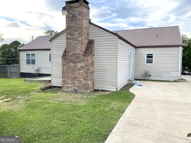 view of side of property with a yard