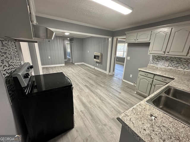 kitchen with heating unit, crown molding, a textured ceiling, and black electric range