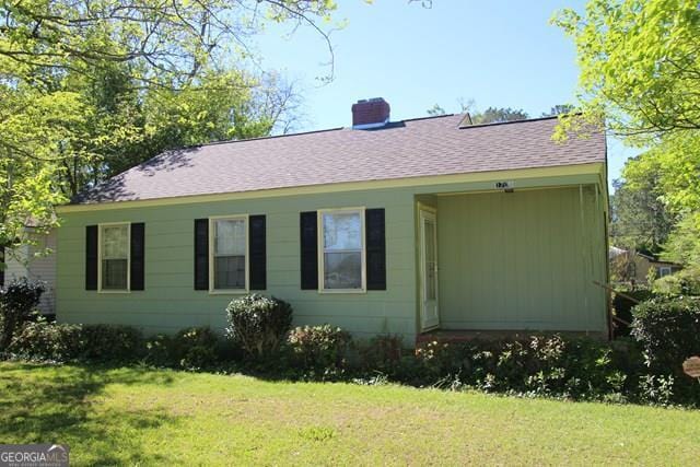 rear view of house with a yard