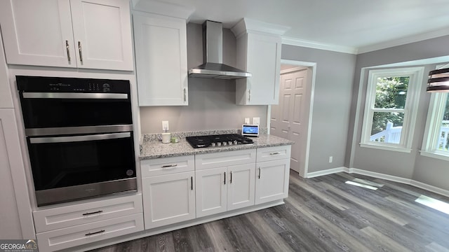 5124 Smoke Rise Dr, Macon, GA 31210 - kitchen with wall chimney range hood, stainless steel gas cooktop, dark wood finished floors, crown molding, and white cabinetry