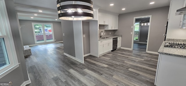 kitchen featuring dark wood-style flooring, white cabinetry, a sink, and baseboards