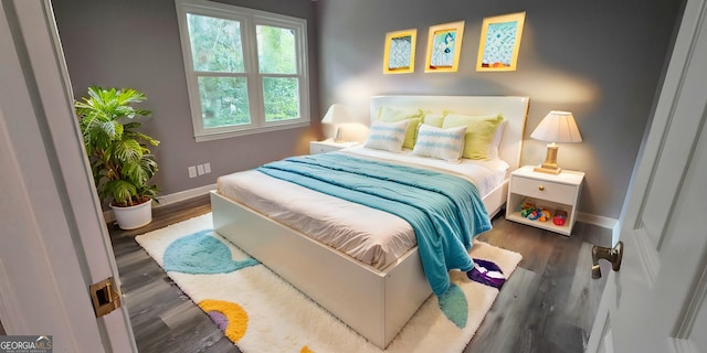 bedroom featuring baseboards and wood finished floors