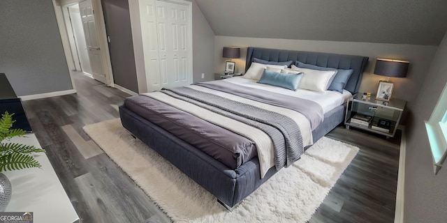 bedroom featuring vaulted ceiling, a closet, wood finished floors, and baseboards