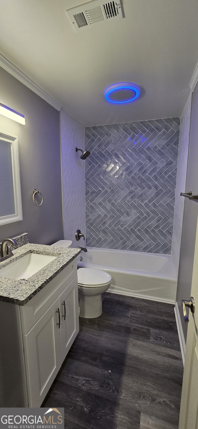 bathroom with crown molding, visible vents, toilet, shower / tub combination, and wood finished floors