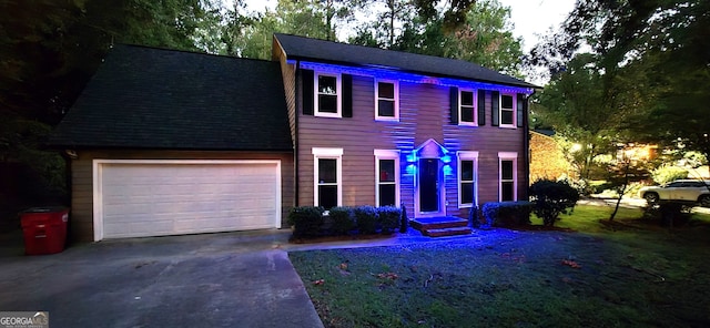 colonial home featuring a garage and concrete driveway