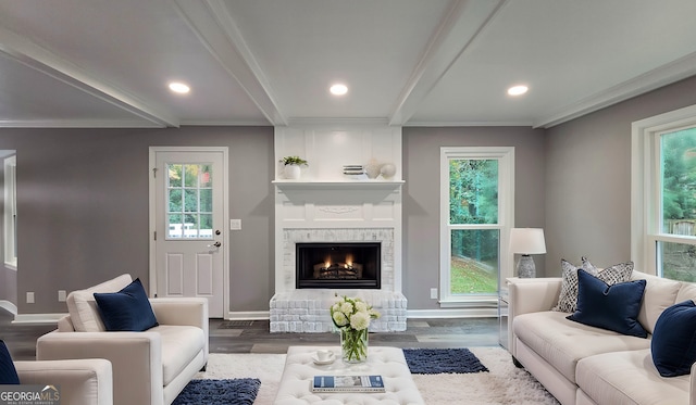 living room with dark wood-style floors, recessed lighting, a large fireplace, beamed ceiling, and baseboards