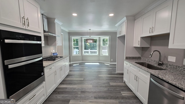 5124 Smoke Rise Dr, Macon, GA 31210 - kitchen with appliances with stainless steel finishes, ornamental molding, wall chimney range hood, white cabinetry, and dark wood-style flooring
