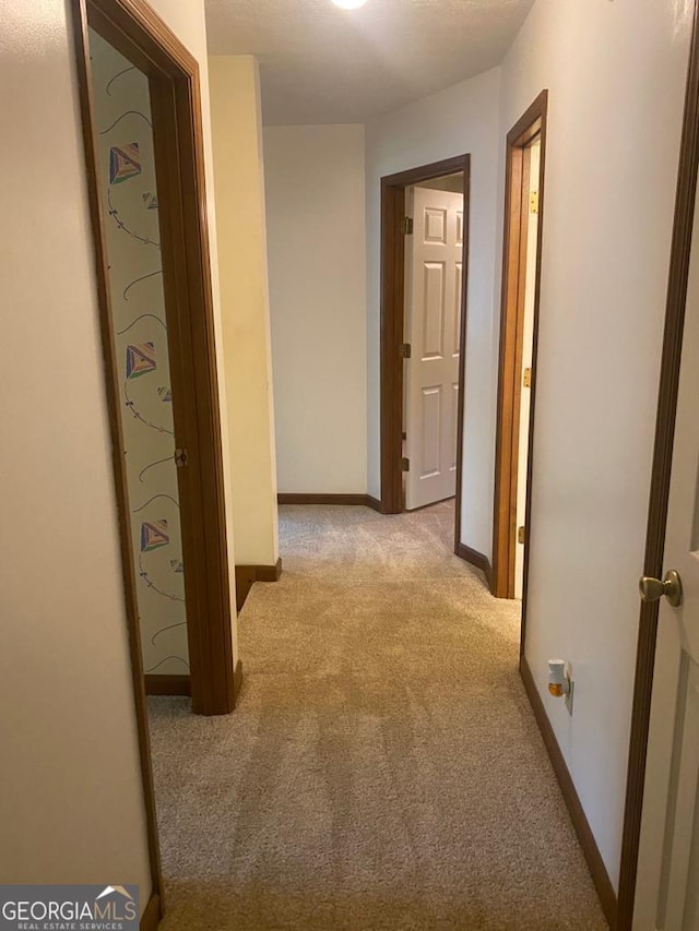 hallway with light colored carpet